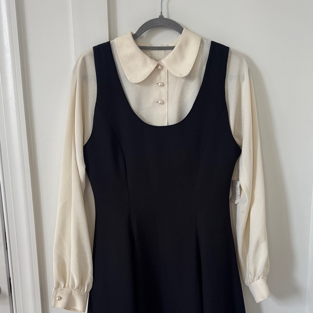 Classic Black Sleeveless Dress with Cream Blouse Layered Look